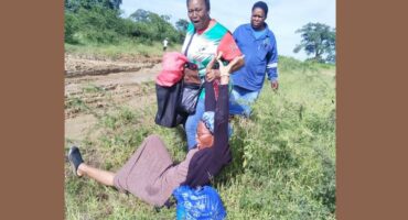 Teacher Goodness Shabangu fell on the muddy ground and her colleague Nomvula Mculu picked her up while another colleague Alucia Chiloane looked on. >Photo: Supplied/Nomvula Mculu