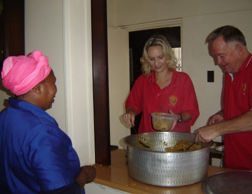 Olivia Allison and Derek Hucklesby serve food.