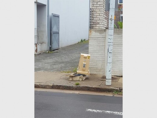 An electrical box damaged by trucks using Juniper Road.