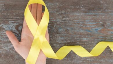 yellow-ribbon-childhood-cancer-awareness-symbol-wooden_179068-1776