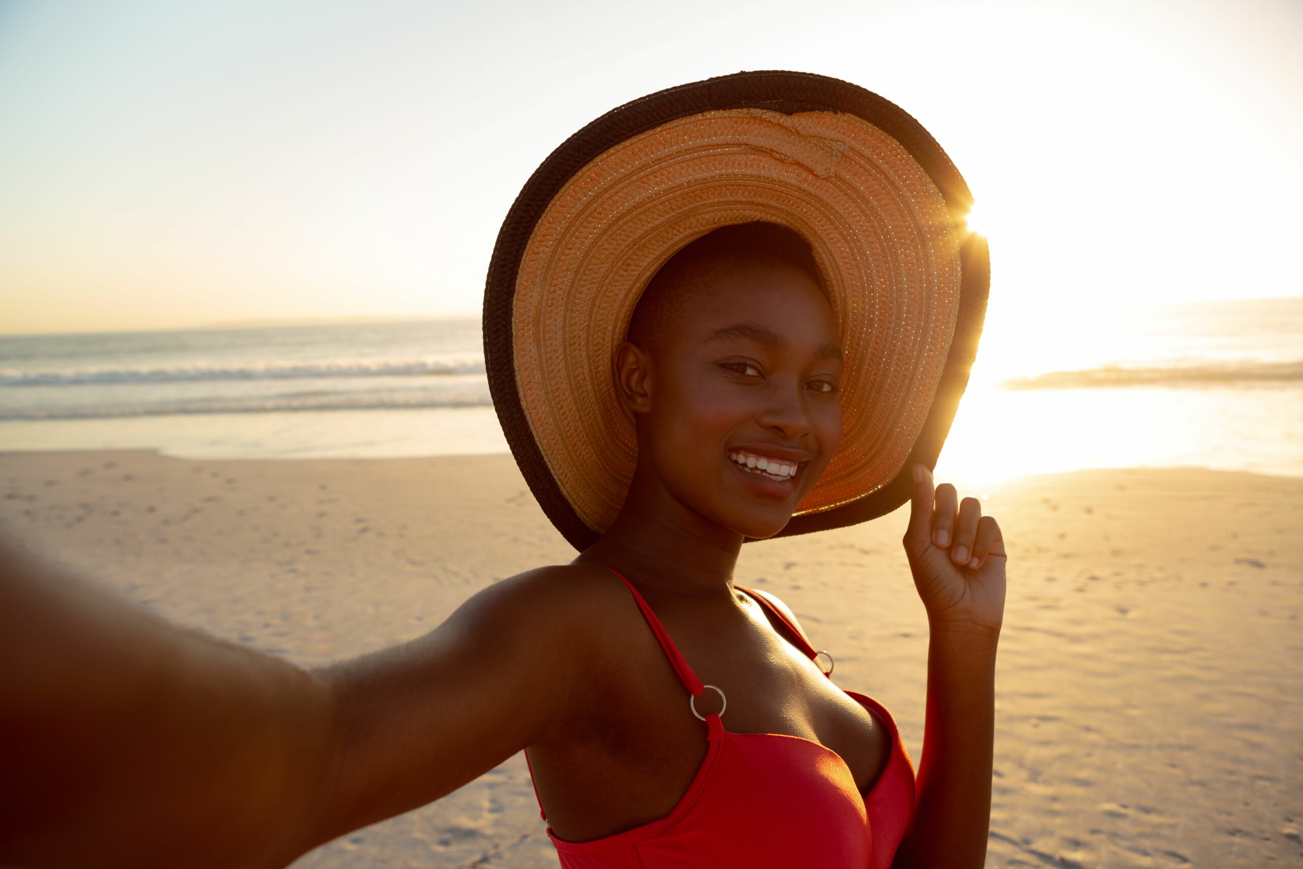 happy-woman-hat-standing-beach