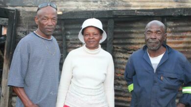 Patrick Chauke, Jane Mogale (ward committee member and patroller) and Thomas Maluleke stand at the site of the fire. Photo: Alulutho Siboma