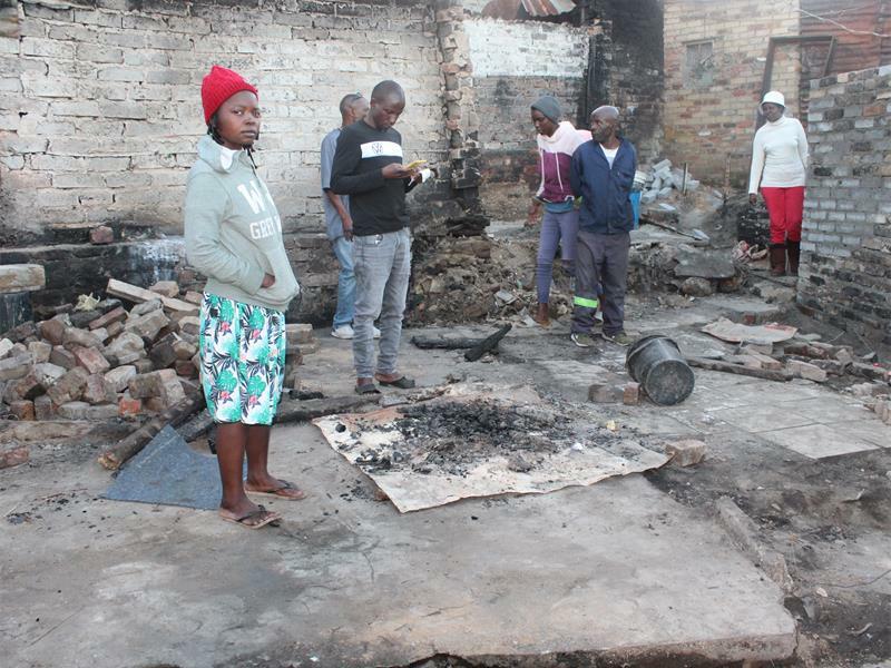 Some residents clean and tidy up the remains of their shacks. Photo: Alulutho Siboma