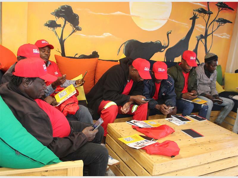 Some of the mechanics on their phones learning more about the website and the latest lubricants technology. Photo: Alulutho Siboma