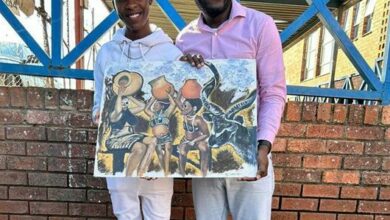 Thabiso Seduma and Nungelo Chiume hold one of his artwork that celebrates African culture. Photo: Supplied