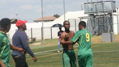 One of the feuding players of Alex Arsenal City FC is restrained by fellow teammates and technical staff. Photo: Sipho Siso