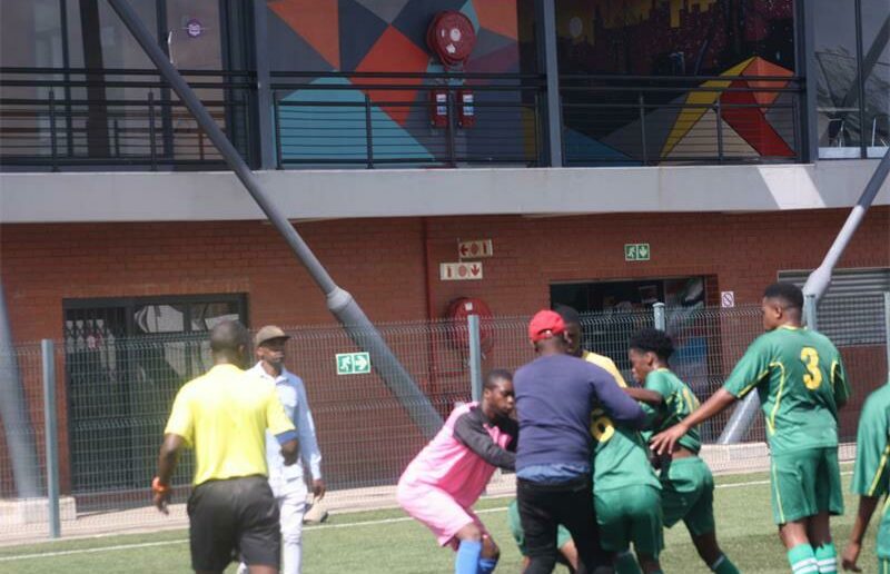 A referee comes to the rescue as well in the hope the teammates will stop their fight. Photo: Sipho Siso
