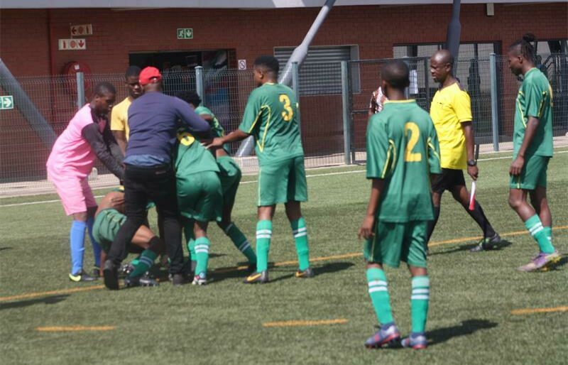 Coaching staff and fellow players had a hard time trying to stop the fight between teammates and a referee had to intervene as well. Photo: Sipho Siso