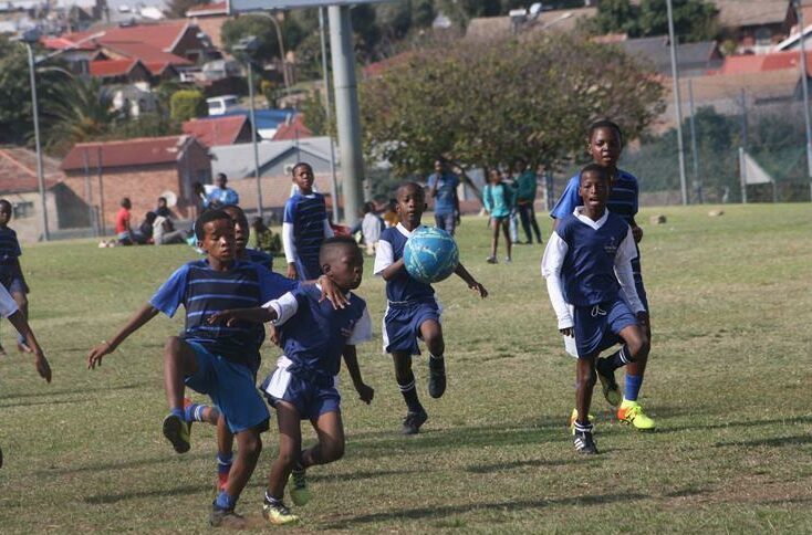 A tussle for the ball between a Linda Stars defender and a Blue Aces attacker (blue and white) in the preliminary round of the Map Games. Photo: Sipho Siso