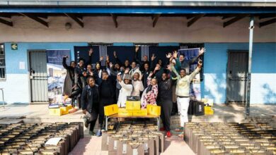 The Flanagan & Gerard team hands out Bathu shoes to the pupils at the Realogile High School in Alexandra.