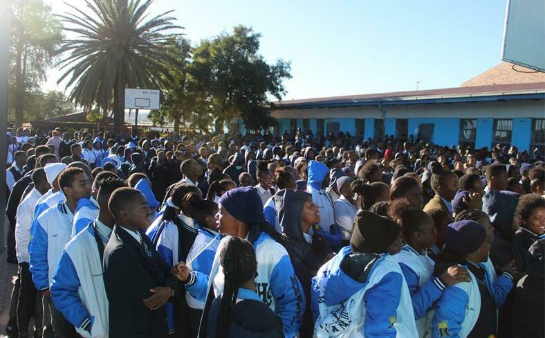 Learners at Realogile High School assemble to listen and watch the handover of matric dresses and suits by the Gomora television series cast members. Photo: Alulutho Siboma