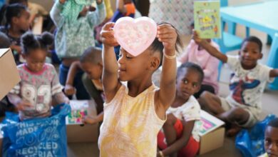 A child holds up a heart. Photo: Supplied