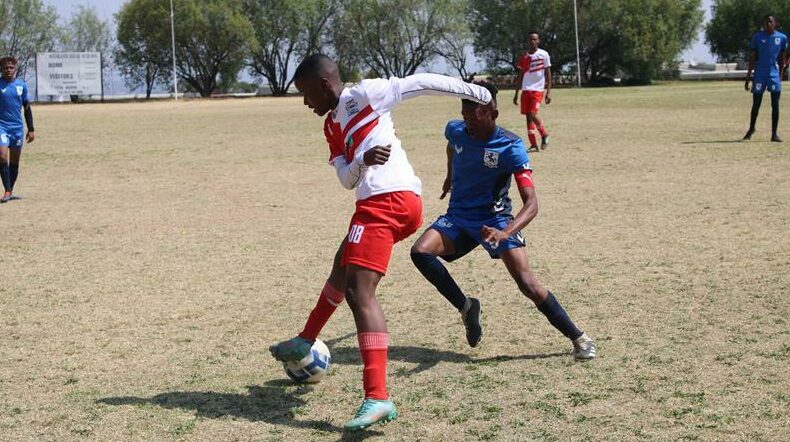 Ponelopele Oracle Secondary School (red and white) take on Sandown High School in the Sanlam Kay Motsepe School Cup at Midrand High. Photo: Comfort Makhnaya