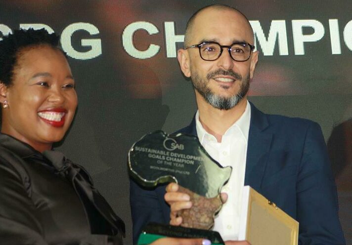 Small Business Development Minister Stella Ndabeni-Abrahams hands over an award to Woolworths' head of sustainability Feroz Koor at the SAB Beyond Awards. Photo: Sipho Siso