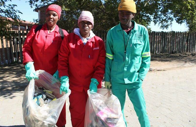 Alexandra Water Warriors volunteers Noxolo Civatha, Salome Moremi and Thabang Mkhwanazi pose for a picture while they collect the litter near the road during the clean-up campaign. Photo: Xoliswa Zakwe