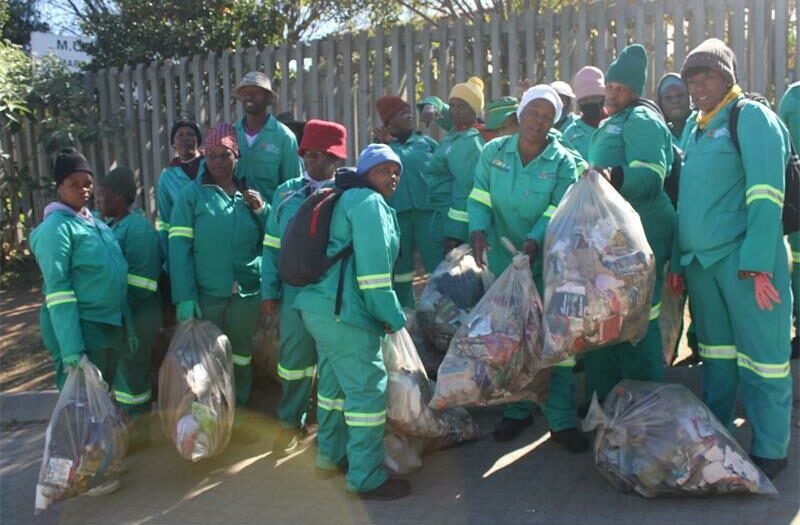 Community volunteers show excitement as they clean their environment. Photo: Xoliswa Zakwe