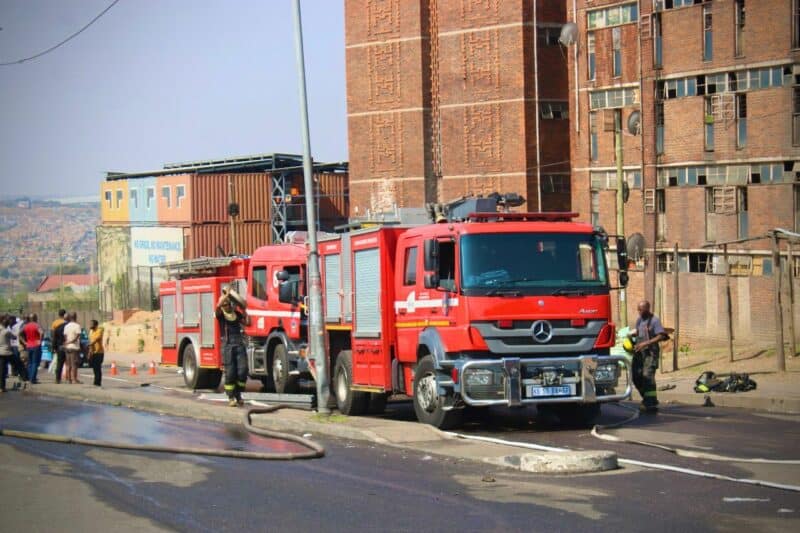 After a fire left nine residents homeless at Madala Hostel, the DA is demanding its immediate inclusion in Gauteng’s redevelopment programme, but the city says it’s already included in the new strategy to redevelop city-owned hostels.