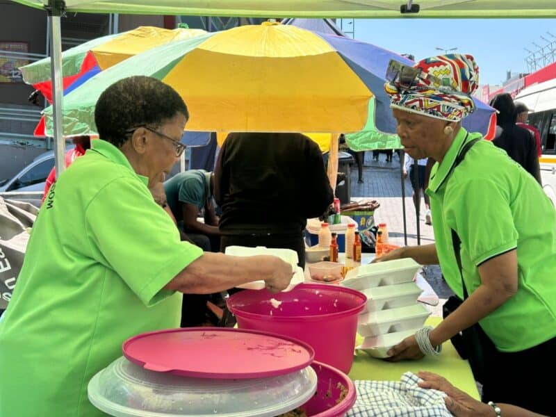 Ageing With Wisdom’s soup kitchen now serves warm meals at Pan Africa Shopping Centre, offering relief and dignity to pensioners facing hunger and exhaustion after queueing for hours to get their SASSA grants.