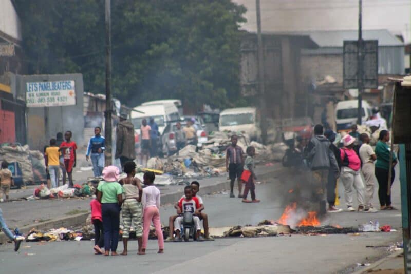Residents forced their way into the house to put out the flames, fearing the fire would spread as protests over electricity outages closed London Road.