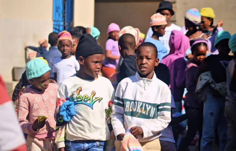 Children in Alexandra received special reflector ‘Halo Beanies’ on Friday, designed to make them more visible to drivers after dark.