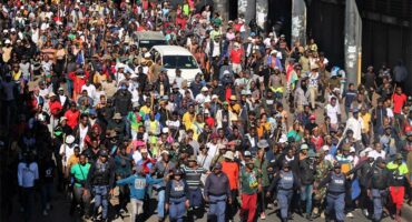 Police officers maintain walk ahead of scores of residents who decided to take it to the street to march against undocumented migrants iin Alexandra on June 30, 2026. Photo: Itumeleng Maloka
