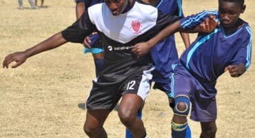 Alec Mailola who plays for Alec Black Poison pushes the ball forward during their clash with Amavulavala FC at Altrec Sports Complex in Alexandra on August 2, 2026.