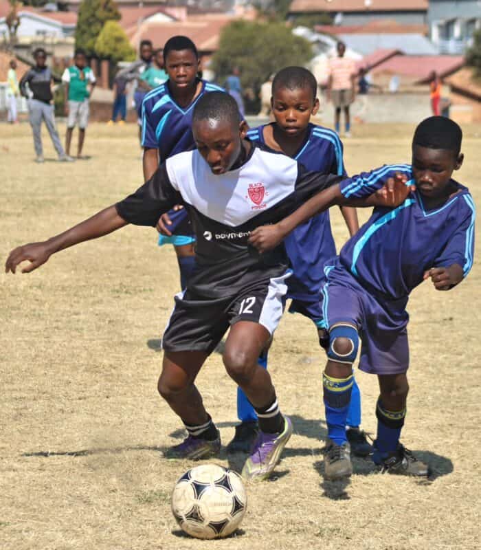 Alec Mailola who plays for Alec Black Poison pushes the ball forward during their clash with Amavulavala FC at Altrec Sports Complex in Alexandra on August 2, 2026.