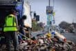 Workers of a private waste collection company clears the waste dumped on Median strip along Vincent Tshabalala Road in Alexandra on July 29, 2026.