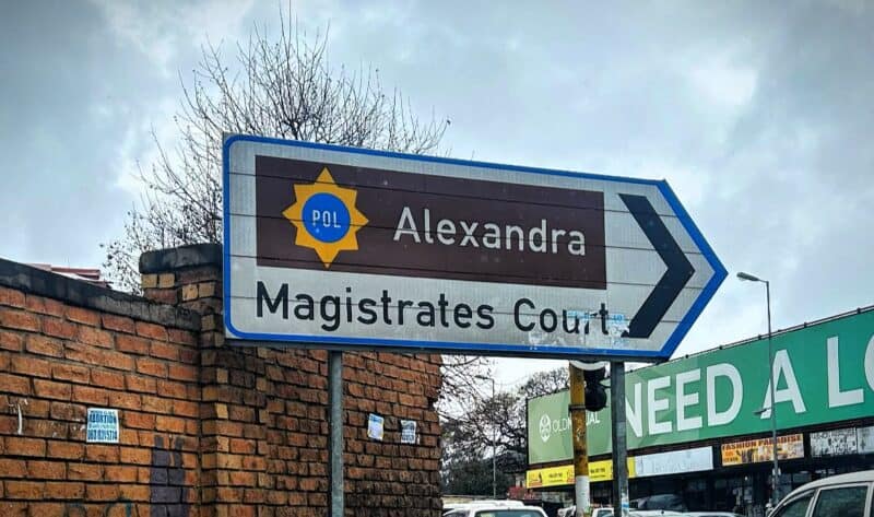 The state says a Home Affairs report proves the e-hailing driver is in the country illegally, but his lawyer says the police can’t even prove if the passport number in the report is linked to him.