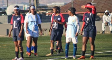 Blue Birds and Mito Stars players wait inside the Blue Birds’ penalty area as a Mito Stars player prepares to take a corner kick during their clash at the Alex Safe Hub on August 15, 2026.