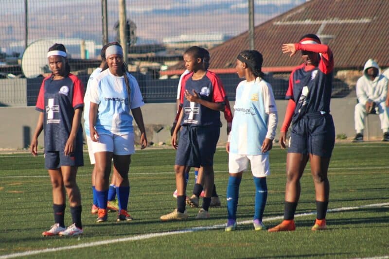 Blue Birds and Mito Stars players wait inside the Blue Birds’ penalty area as a Mito Stars player prepares to take a corner kick during their clash at the Alex Safe Hub on August 15, 2026.