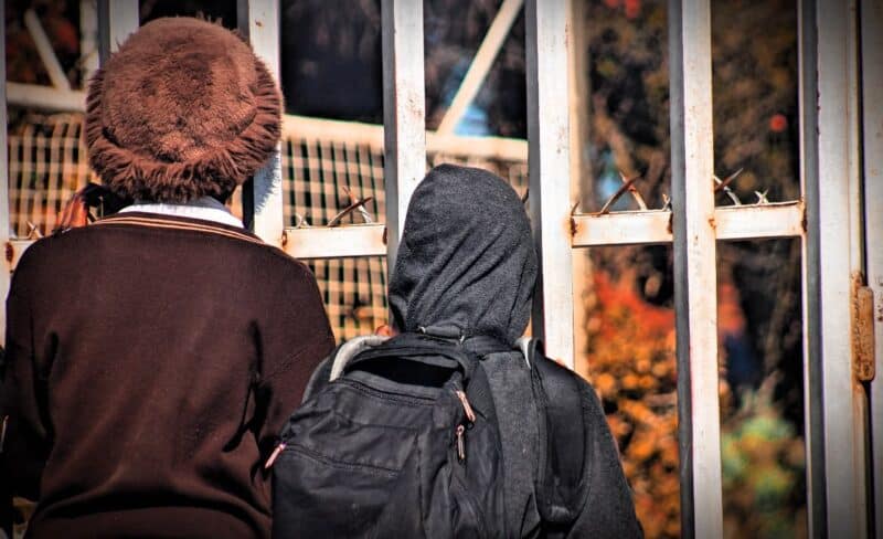 Two Minerva Hugh School learners stand outside the school gates in Alexandra on August 18, 2026. Photo: Itumeleng Maloka