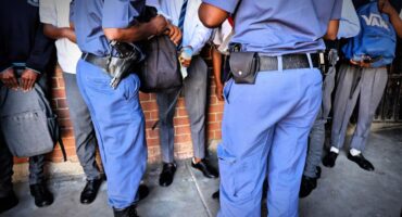 Police officers search learners at Realogile Secondary School in Alexandra. Photo: The Gauteng Department of Education/Facebook
