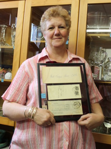 Dianne Leslie, the charity shop manager for Highway Hospice in Pinetown, shows off one of the unique items up for auction at their silent bumper auction, a cheque signed by Cecil John Rhodes in the 1900s