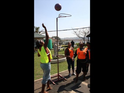 Aiming for the net during a game of netball.