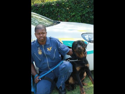 Cst Elliot Mdadane with his new service dog, Hugo.