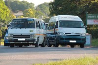 This taxi driving straight over the intersection in the left-only lane at the intersection of Glenugie and Manors Roads.