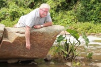 Ward councillor, Andre Mitchell, looks at two dead fish that were found under a boulder in the Umbilo River in Queensburgh.