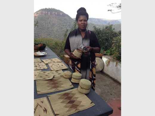One of the crafters, Nokwanda Khumalo with the isithebe and lidded basket she makes.