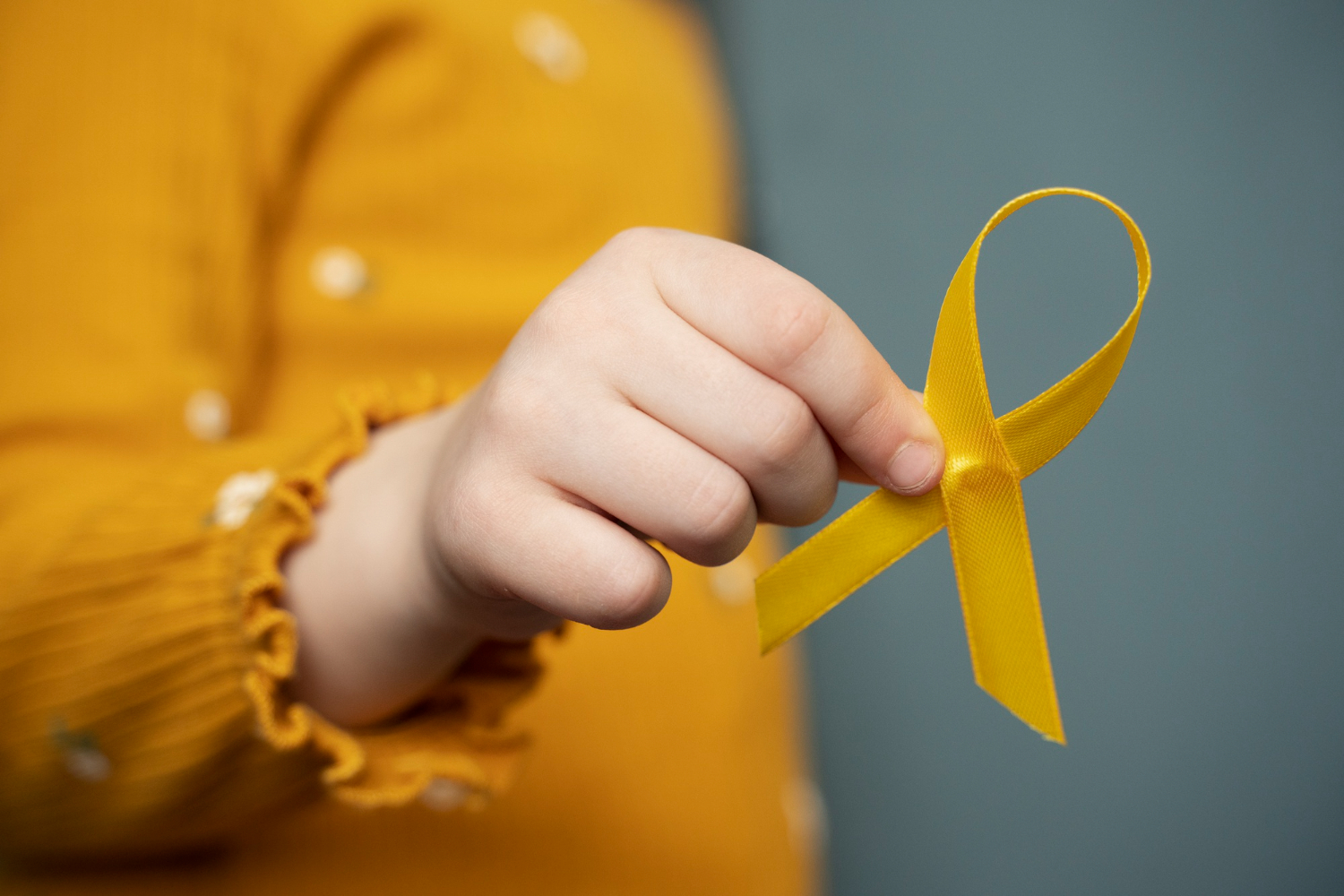 child-holding-yellow-ribbon (1)