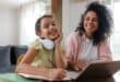a mother and daughter on a laptop