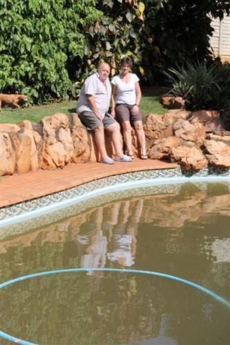 Ian and Anette Barnard from Ranleigh Crescent in Durban North sit beside their pool that was flooded with storm water and sewage last week.
