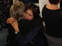 Cameron Dalziel's wife Reine, is comforted by a family member at the memorial.