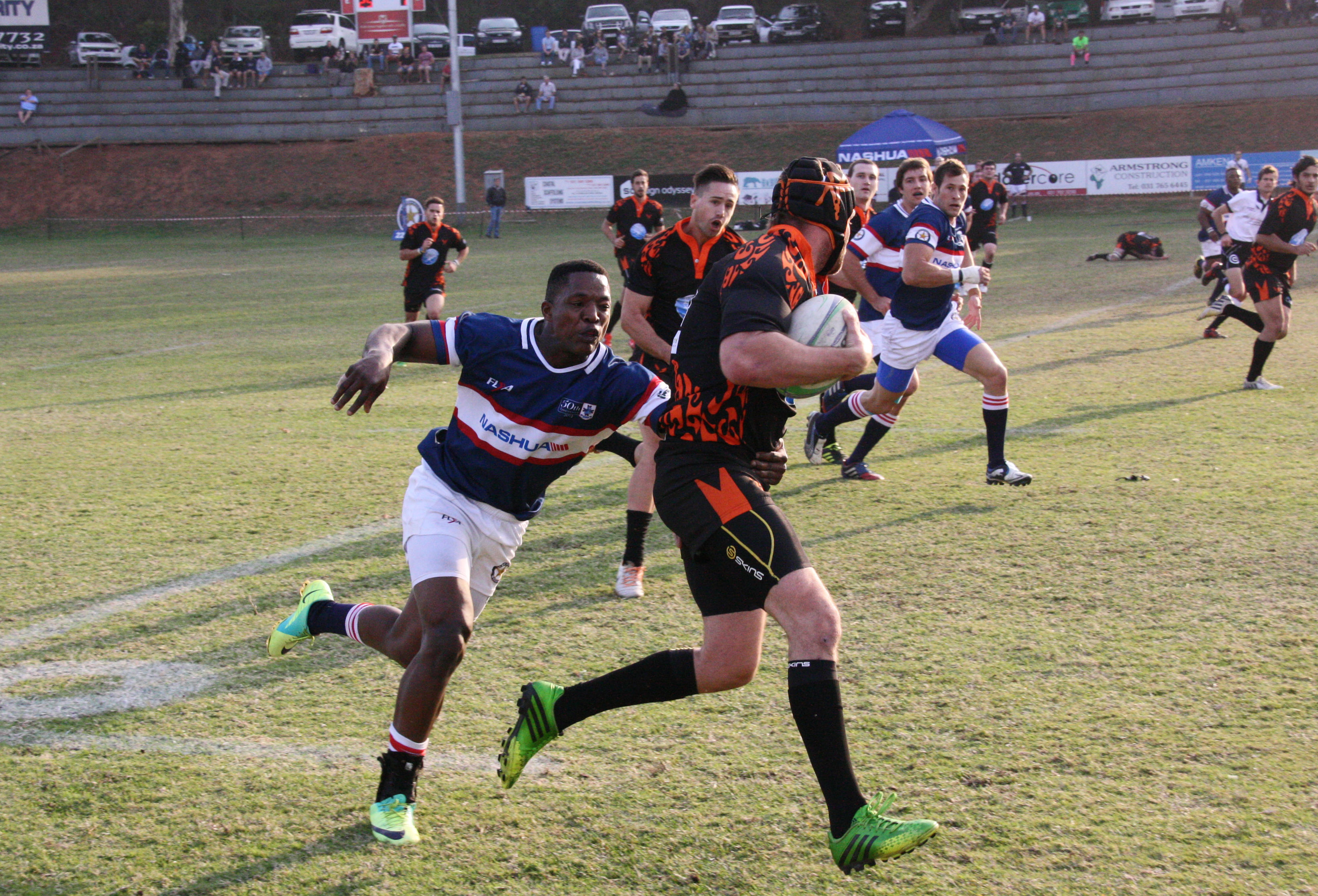 Nashua Crusaders flying winger Charlie Mayeza tracks down a Toti forward. The Saders won the game 18-7.