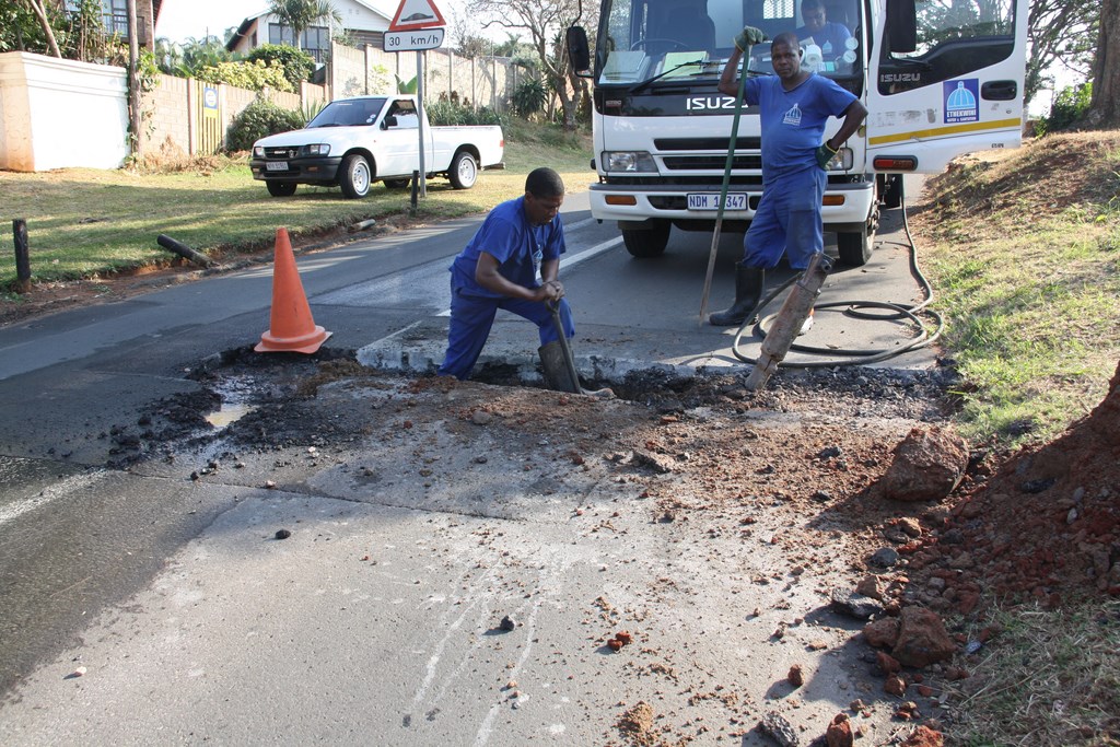 Municipal employees, Nunu Sithole works on a section of Campbell Drive where a leaky pipe has plagued residents for the past 18 months.