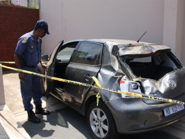 Durban North SAPS warrant officer, Seggie Padayachee, inspects the vehicle which was totaled.