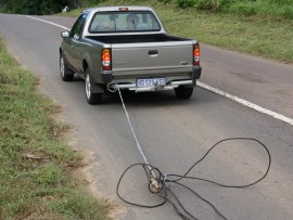 Robin Candy, tows some of the cabling out of the thick bush near the church.