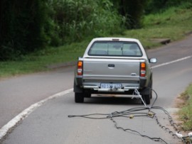 Robin Candy, tows some of the cabling out of the thick bush near the church.