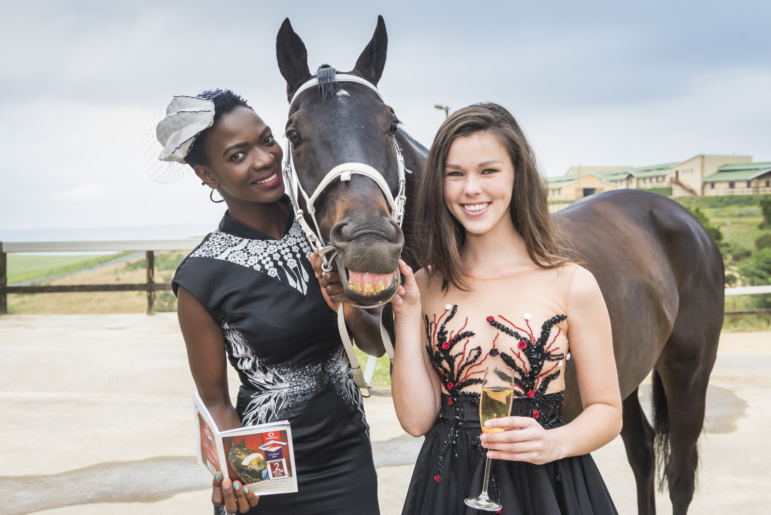 Having a laugh with Vodacom Durban July runner The Conglomerate are Phumala Mtolo (left, outfit by Young Designer finalist Shéskia Aprakshya Ramnath) and Megan Walsh (outfit by Fashion Challenge finalist Joslyn Jack. PHOTO: Anthony Grote (Gameplan Media)