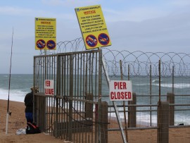 The city have used barbed wire fencing and disclaimers warning fishermen not to fish on the pier.